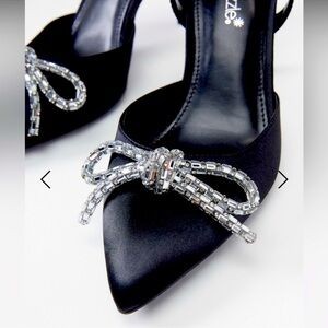 Shoe Dazzle  Black pumps with a rhinestone bow.